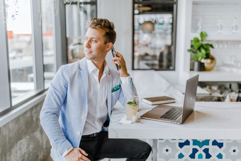 Business man on the phone and working on a laptop.