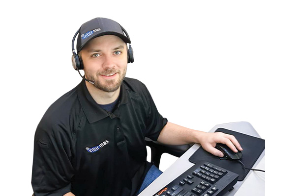 Local Intermax associate with headset and computer keyboard.