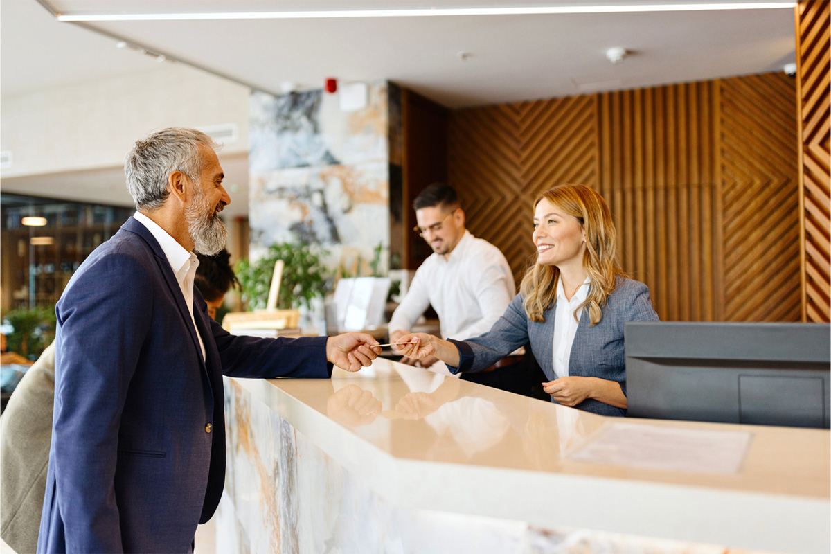 Businessman checking in at a hotel front desk.