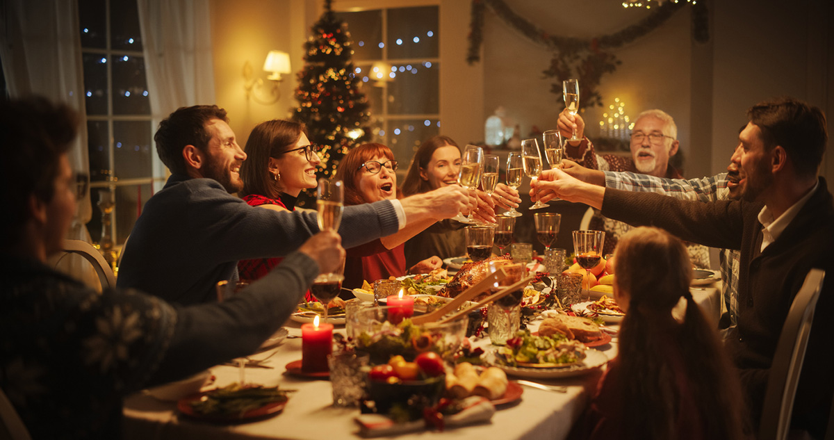 Family and Friends Sharing Meals, Raising Glasses with Champagne, Toasting, Celebrating a Winter Holiday