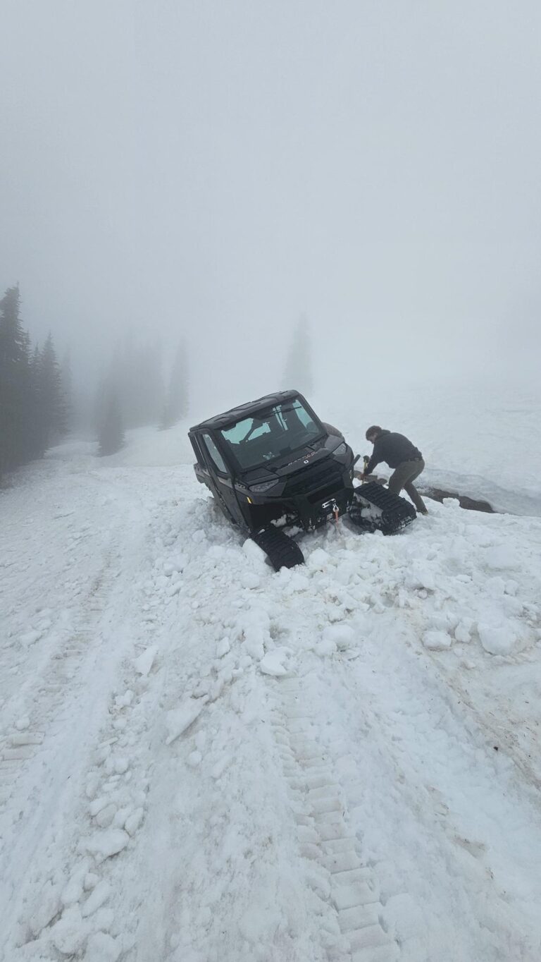 Intermax tech with vehicle stuck in the snow.