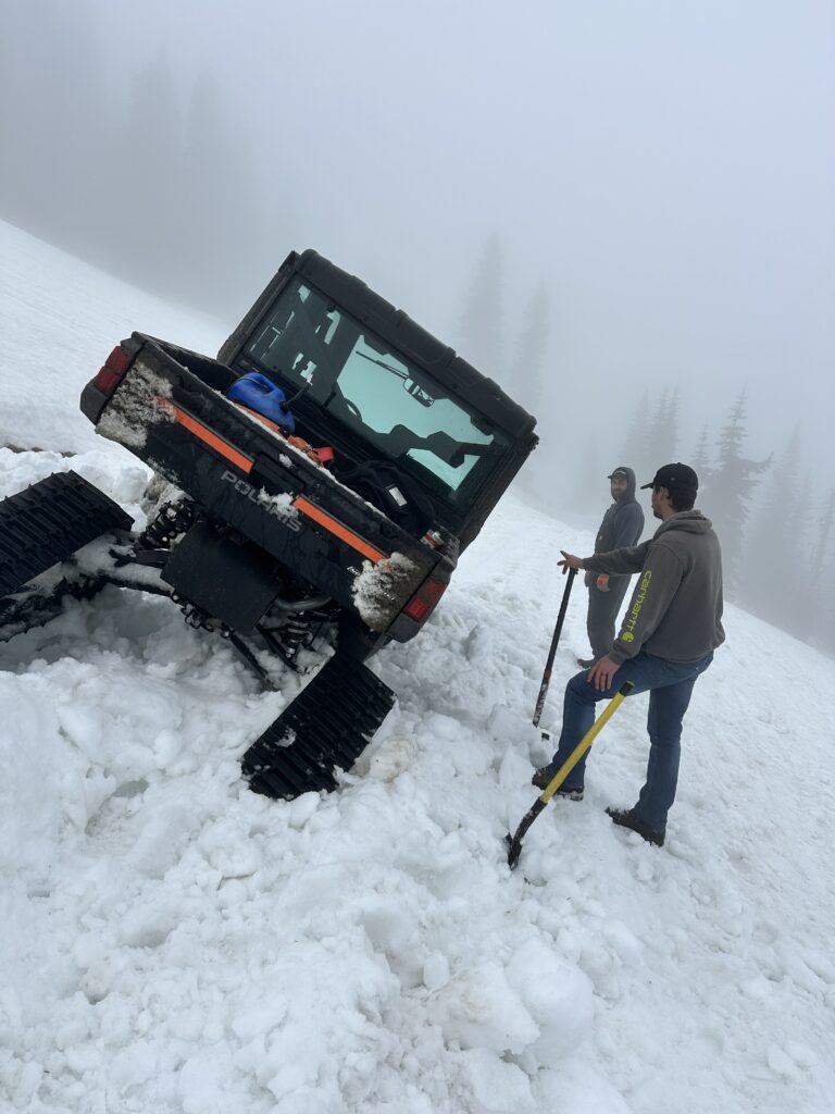 Intermax techs with vehicle stuck in the snow.