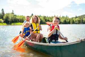 A Family in a Canoe on a Lake.