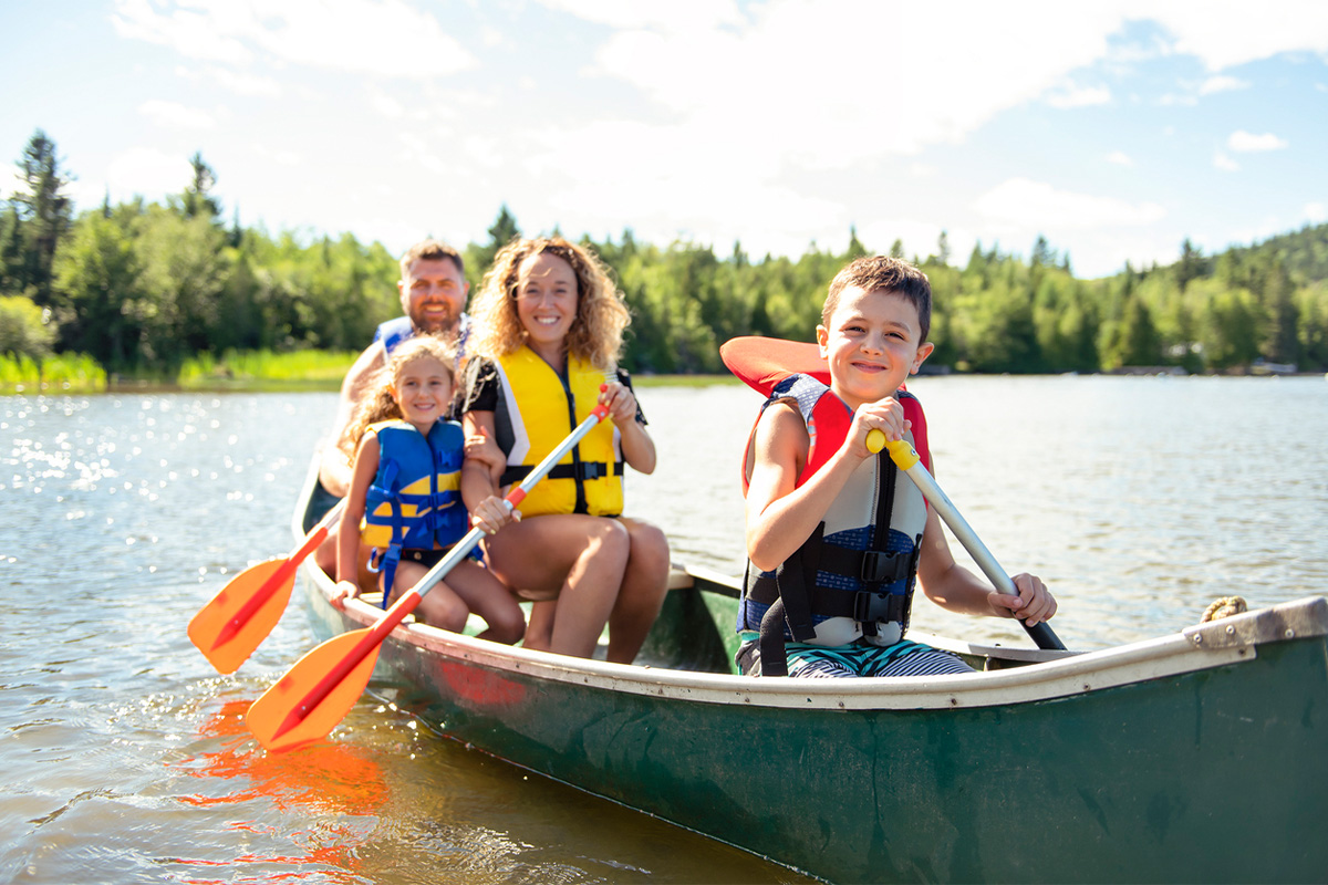 A Family in a Canoe on a Lake.