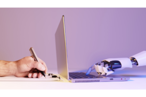 Human hand writing and robot hand using a laptop.