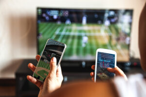 People watching tennis on TV and basketball and baseball on their phones.