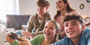 Four kids playing video games.