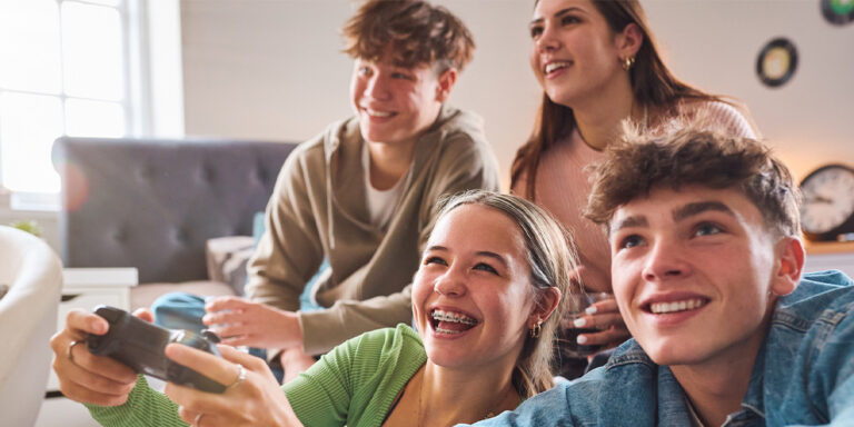 Four kids playing video games.