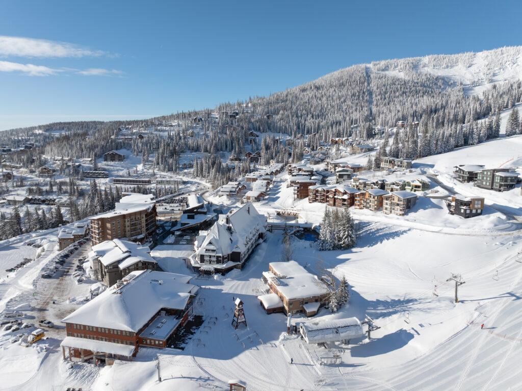 Drone image of Schweitzer Resort on a snowy day with the mountain the the background.