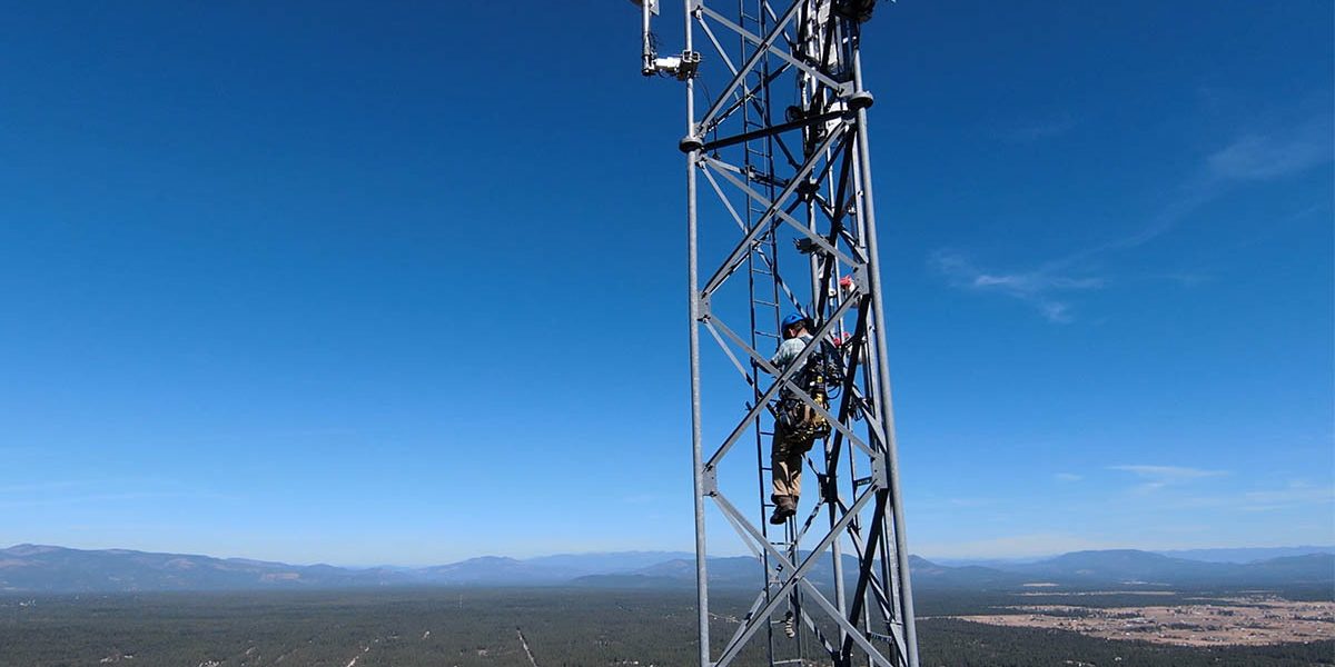 Maintenance technician on an Intermax Networks tower overlooking Northern Idaho.