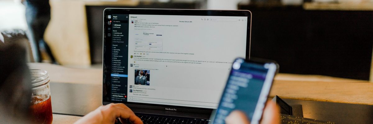 Man works on laptop and phone at the same time