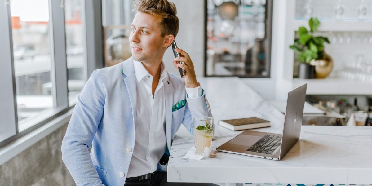 Business man on the phone and working on a laptop.