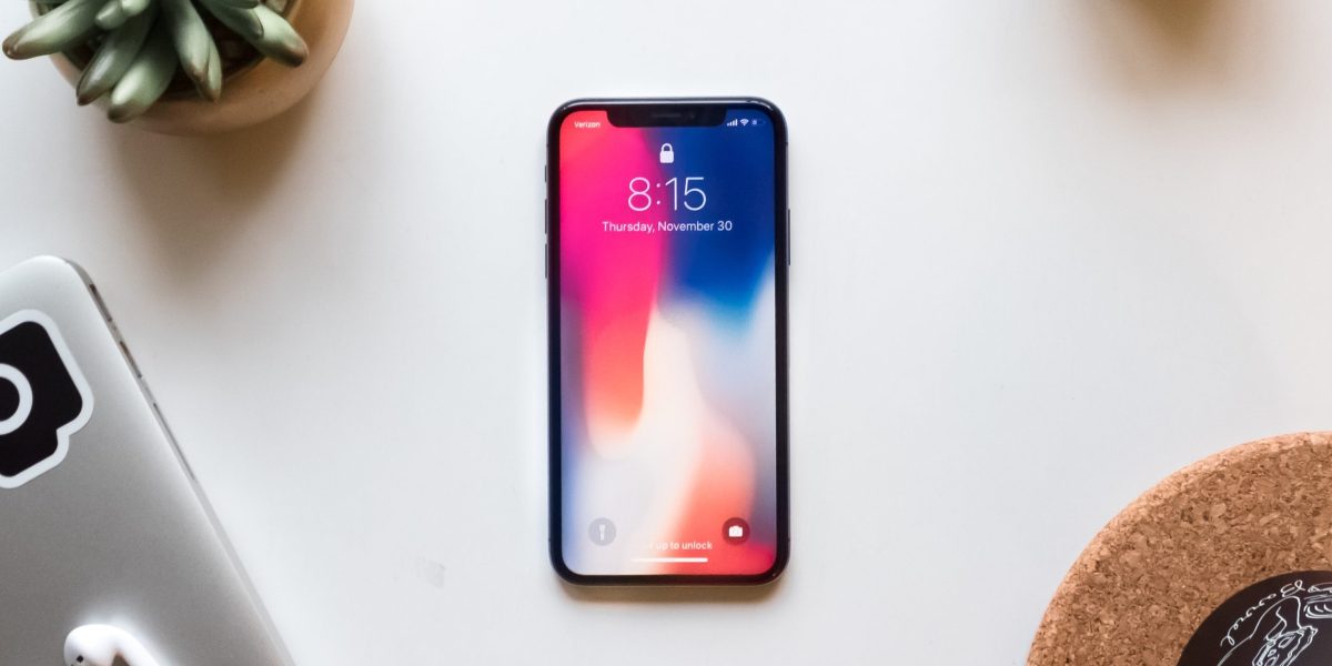 Phone lying on table near other wireless devices