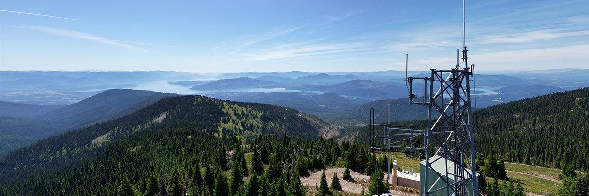 The view from the Intermax Networks' tower on Bald Mountain with mountains and a lake in the distance.