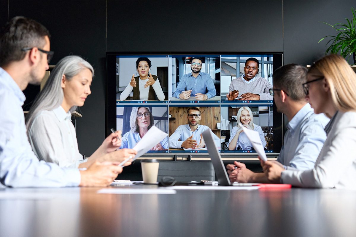 intermax-5-reasons-to-bundle-services-2 Video conference with colleagues on a screen and in person.