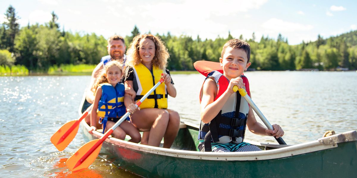 A Family in a Canoe on a Lake.
