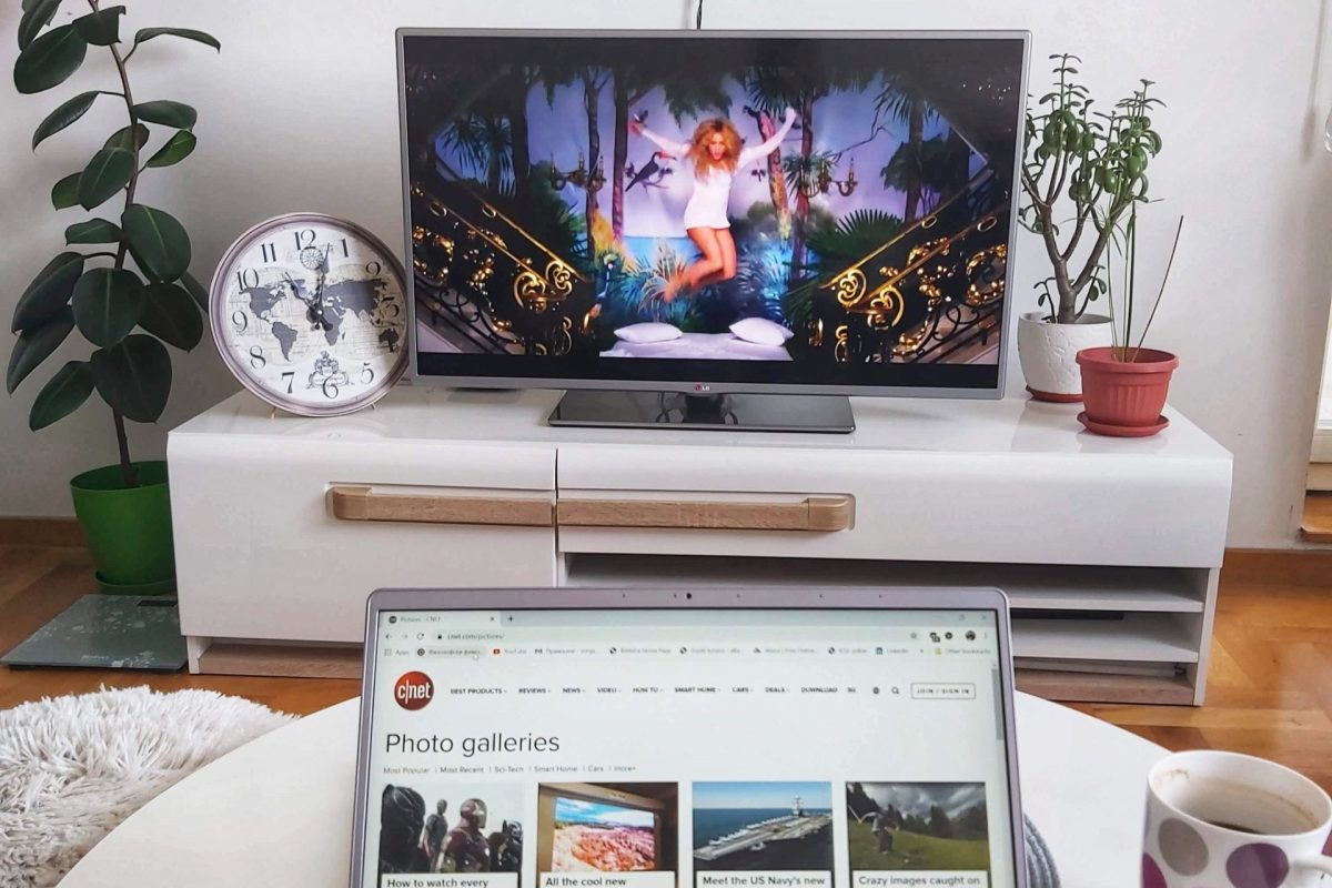 minja-radonja-mAa9SCLfuGg-unsplash Laptop sits on table in front of TV