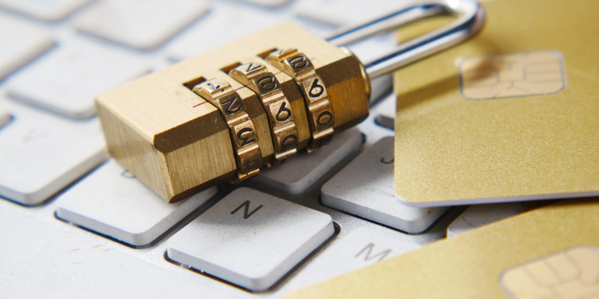 Number lock lying on keyboard nest to credit cards