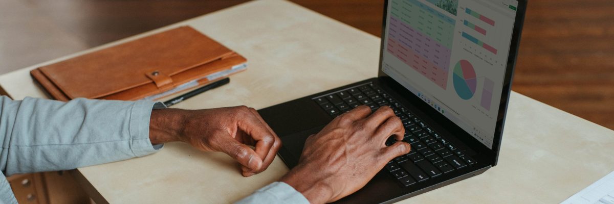 Man works at computer showing analytics at home