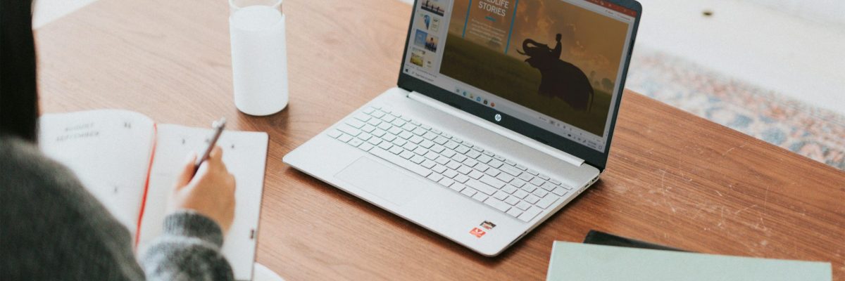 Woman working on a PowerPoint on her computer.